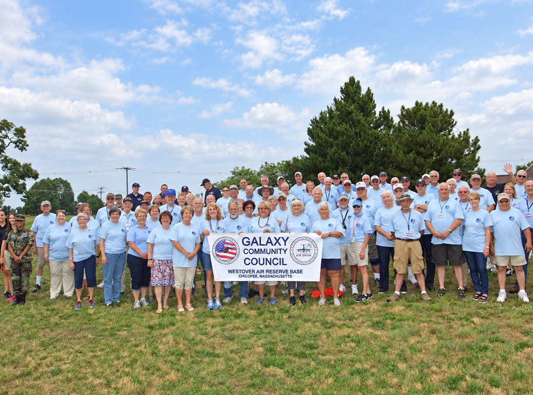 Galaxy Community Council Group Photo Galaxy Community Council members gather for a group photo while holding the organization’s banner.