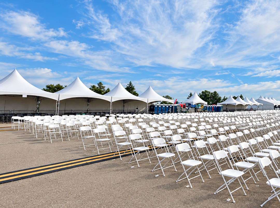Premium Box Seating Rows of white chairs arranged in the Premium Box Seating area, with large canopy tents positioned behind them.