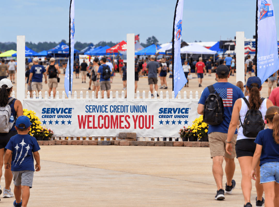 Visitors enter an airshow through a sponsor-branded welcome area.